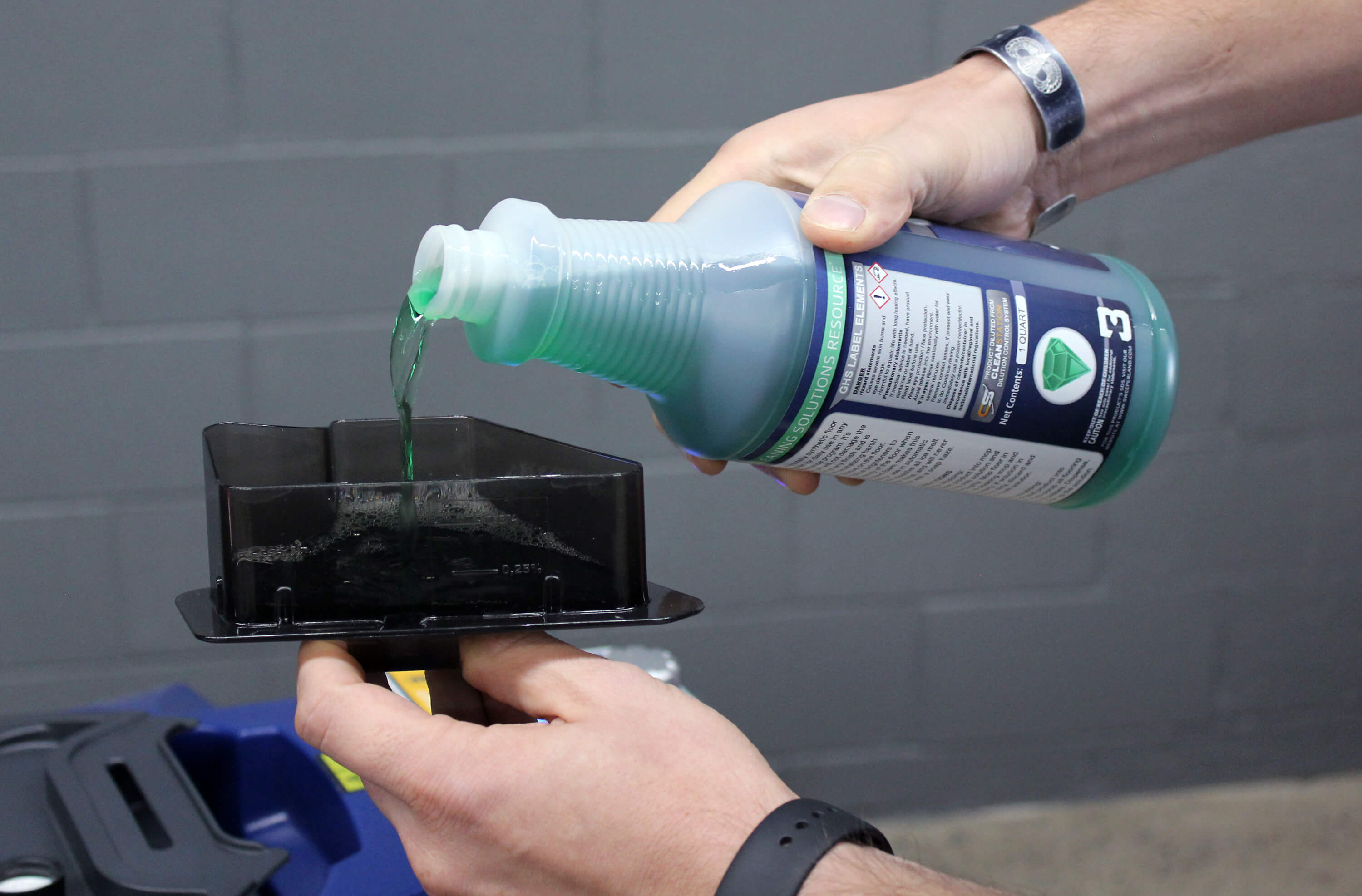 Pouring chemical solution into floor scrubber