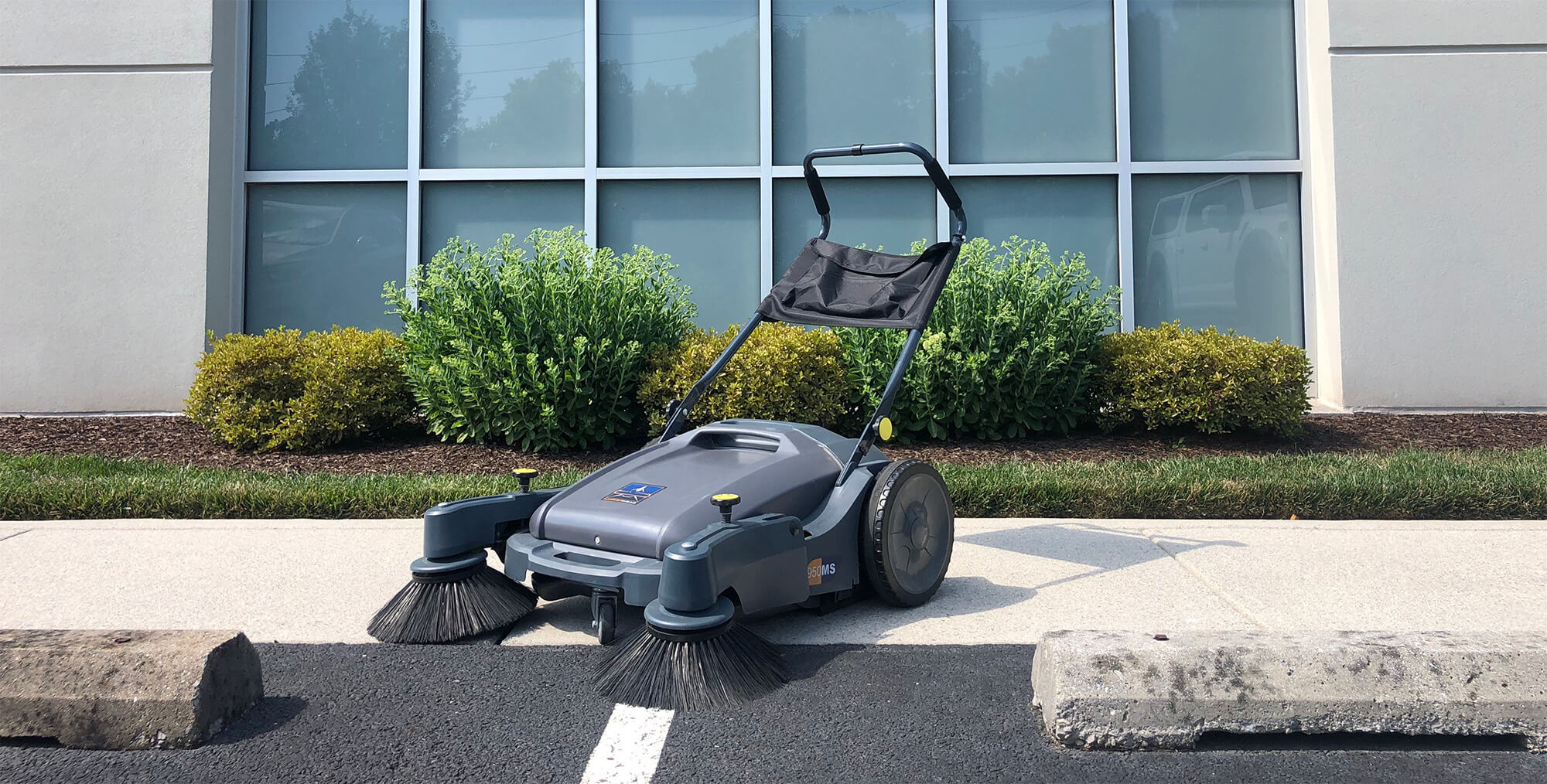 950MS Manual Sweeper on Sidewalk